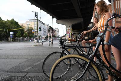 Waiting for the traffic light Young women on bicycles in Berlin wait at a stop light